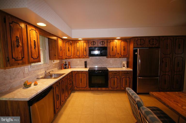 9504 Dundawan Road Nottingham, MD 21236 - Photo 28 of 30 a kitchen with granite countertop a sink stove and refrigerator