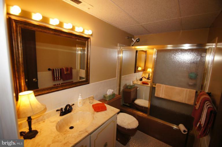 9504 Dundawan Road Nottingham, MD 21236 - Photo 4 of 30 a bathroom with a sink and mirror