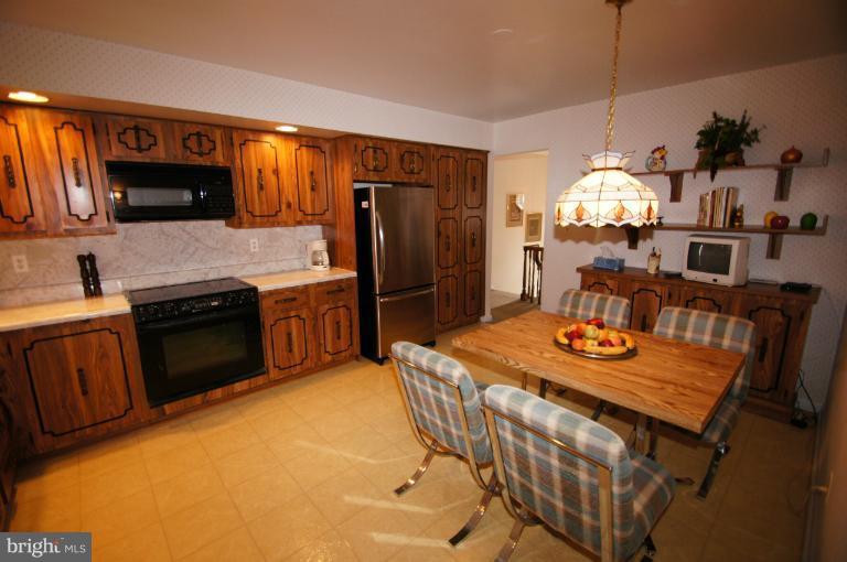9504 Dundawan Road Nottingham, MD 21236 - Photo 6 of 30 a kitchen with stainless steel appliances granite countertop a sink a stove and refrigerator
