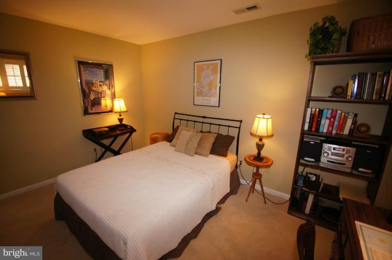 9504 Dundawan Road Nottingham, MD 21236 - Photo 10 of 30 a bed room with a bed and a book shelf