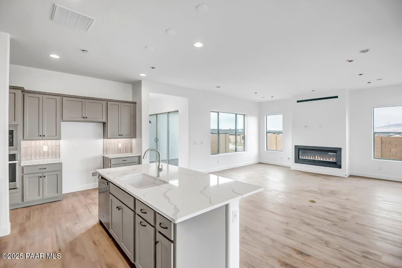 5229 Iron Vine Trail Prescott, AZ 86301 - Photo 13 of 92 a kitchen with stainless steel appliances granite countertop a sink stove and refrigerator