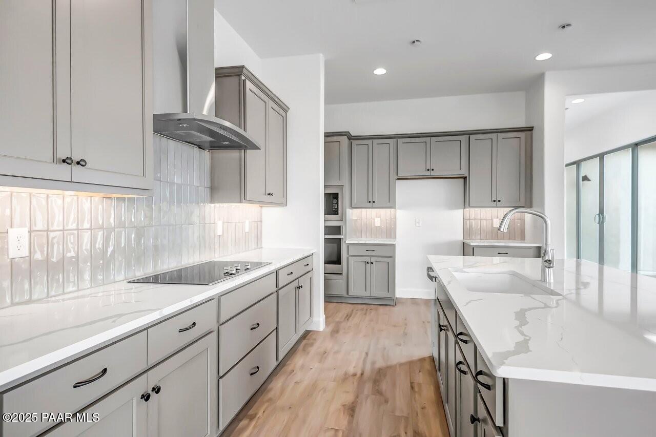 5229 Iron Vine Trail Prescott, AZ 86301 - Photo 14 of 92 a kitchen with white cabinets sink and stainless steel appliances