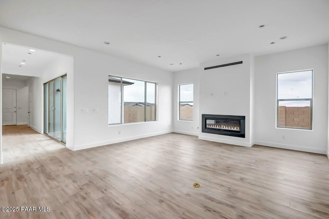 5229 Iron Vine Trail Prescott, AZ 86301 - Photo 17 of 92 a view of an empty room with a fireplace and a window