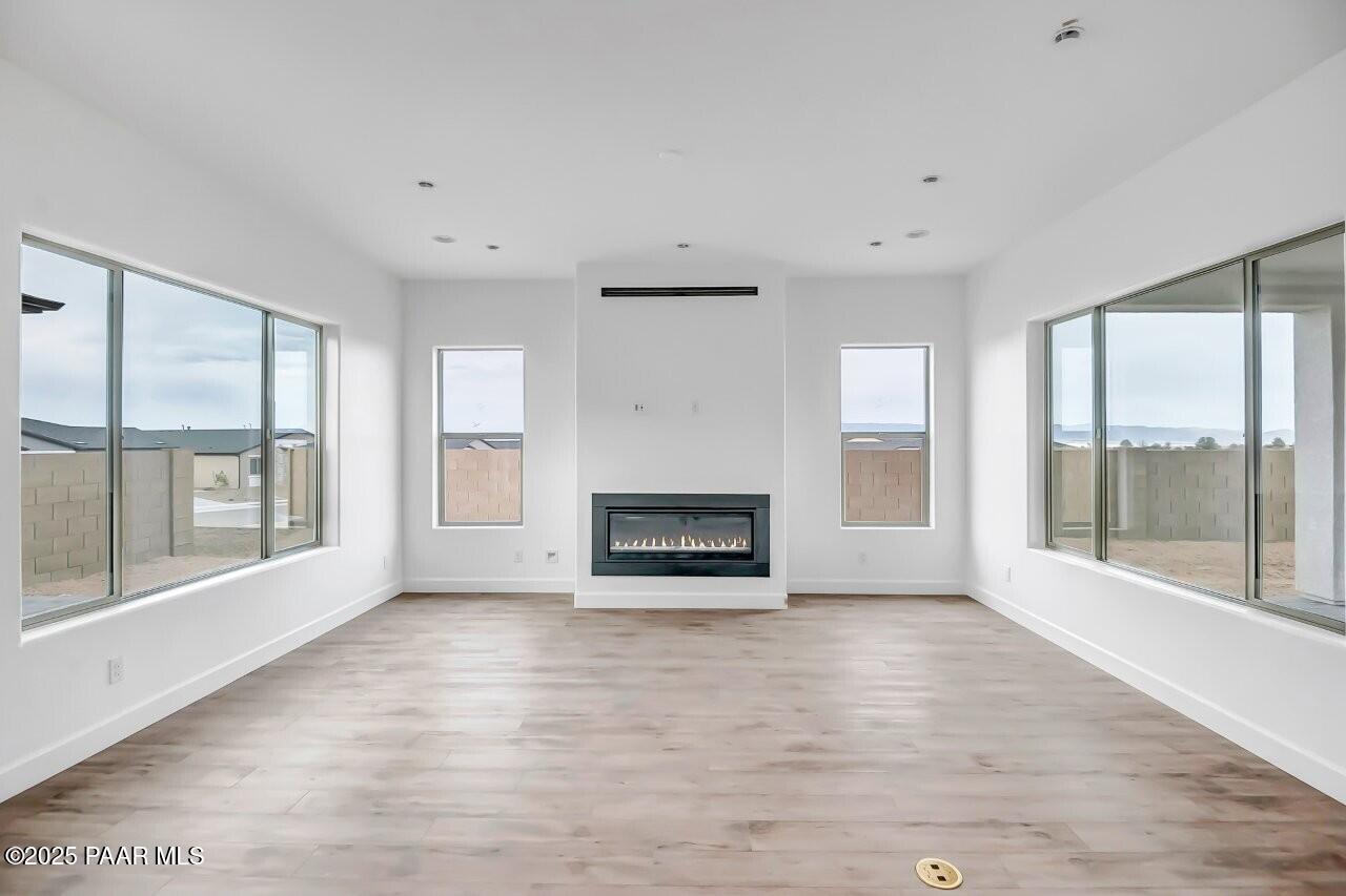 5229 Iron Vine Trail Prescott, AZ 86301 - Photo 18 of 92 a view of a big room with windows and fireplace