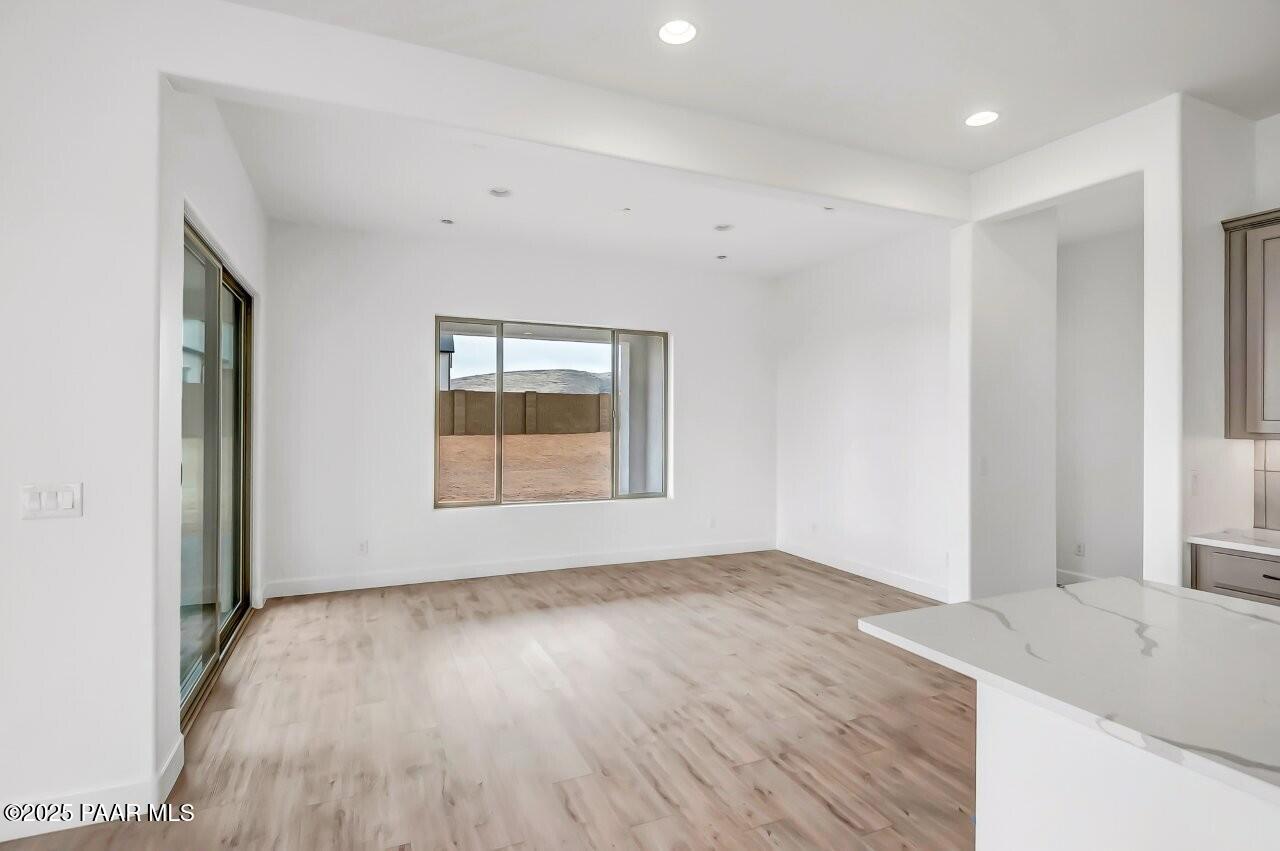5229 Iron Vine Trail Prescott, AZ 86301 - Photo 19 of 92 a view of empty room with wooden floor and fan