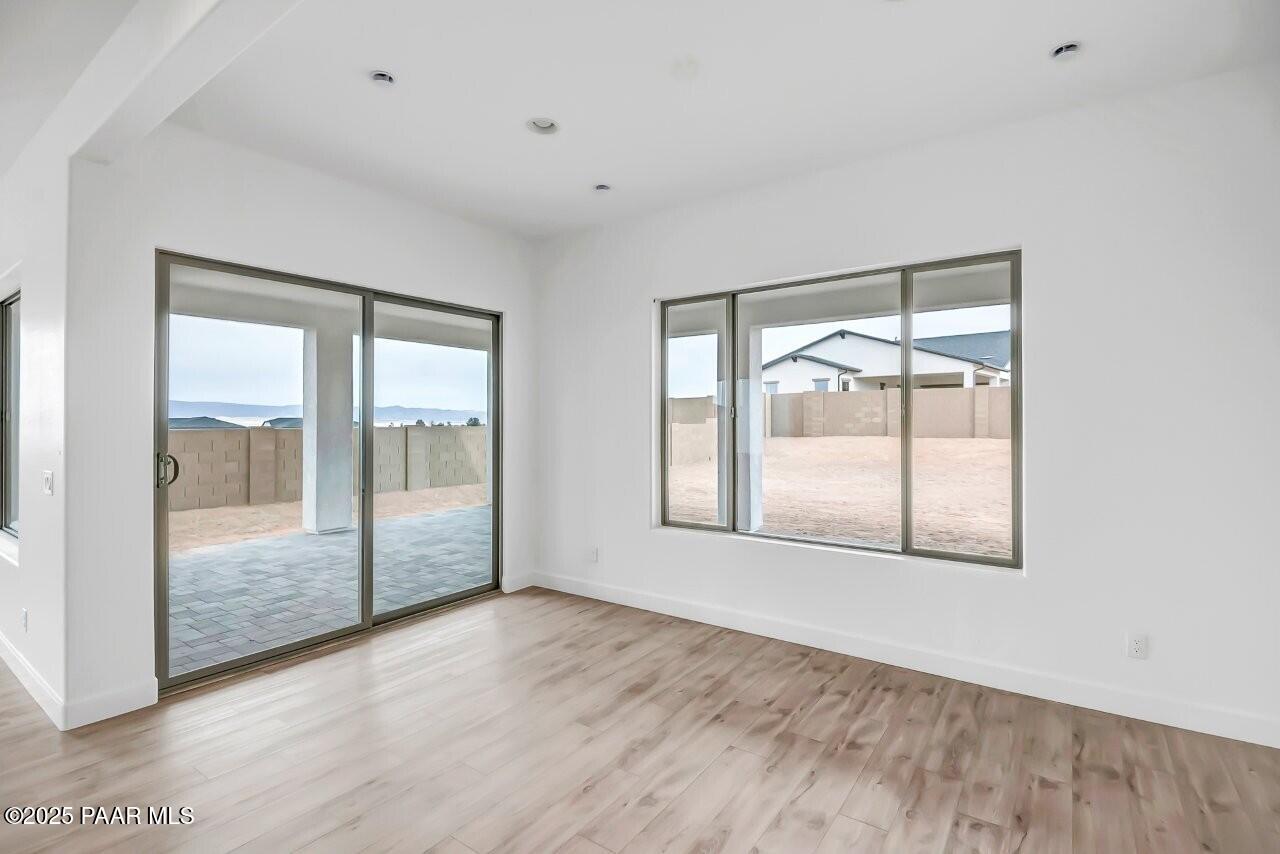 5229 Iron Vine Trail Prescott, AZ 86301 - Photo 20 of 92 an empty room with wooden floor and windows