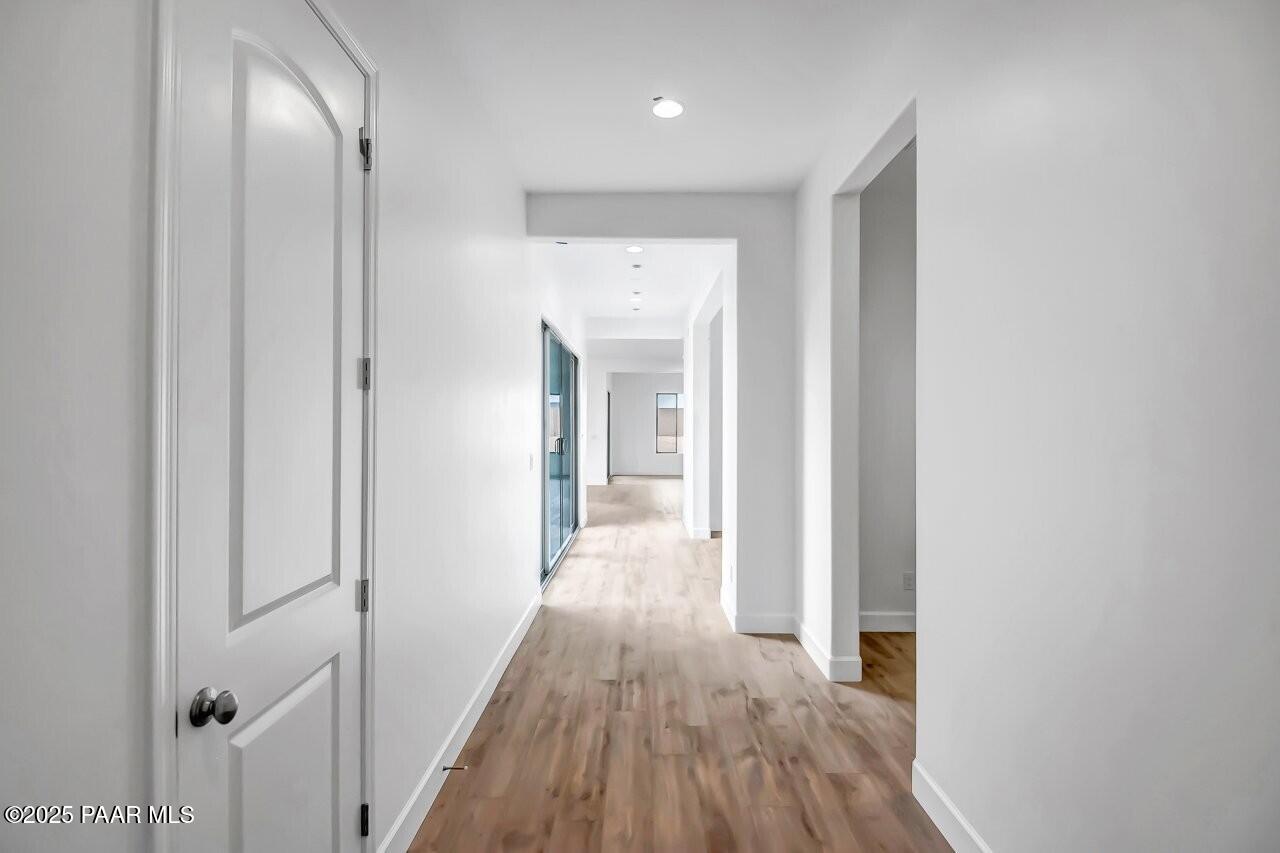 5229 Iron Vine Trail Prescott, AZ 86301 - Photo 22 of 92 a view of a hallway with wooden floor