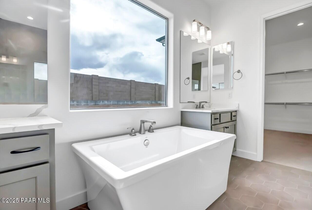 5229 Iron Vine Trail Prescott, AZ 86301 - Photo 29 of 92 a bathroom with a sink a mirror and a bathtub