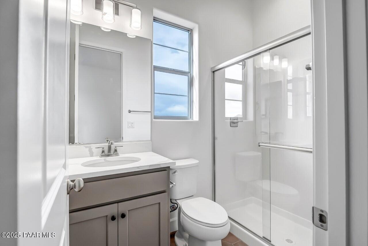 5229 Iron Vine Trail Prescott, AZ 86301 - Photo 38 of 92 a bathroom with a sink toilet vanity and shower