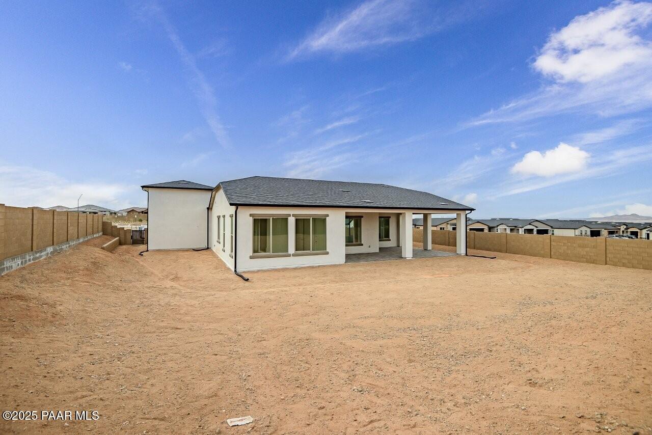 5229 Iron Vine Trail Prescott, AZ 86301 - Photo 47 of 92 a front view of house with yard and trees in the background
