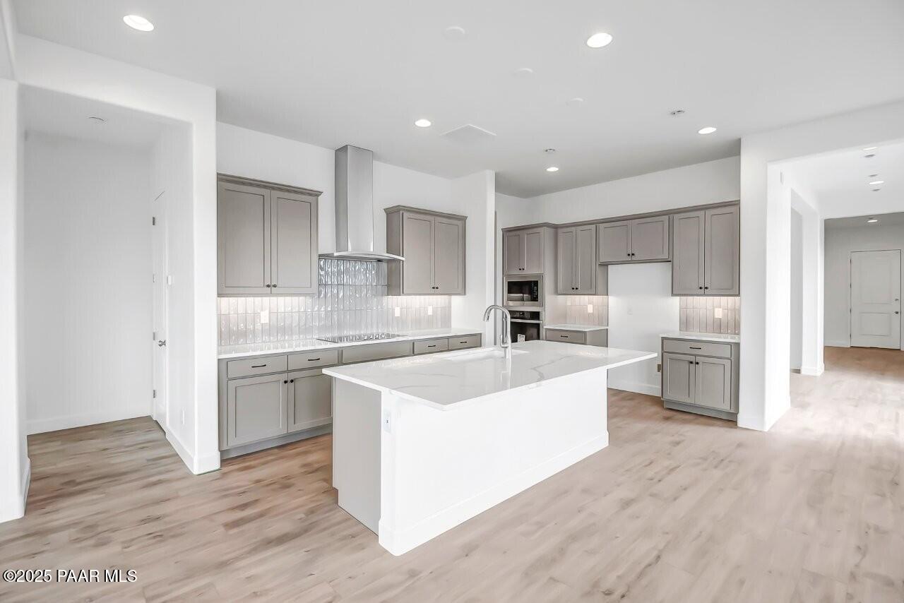 5229 Iron Vine Trail Prescott, AZ 86301 - Photo 6 of 92 a large kitchen with stainless steel appliances lot of white cabinets