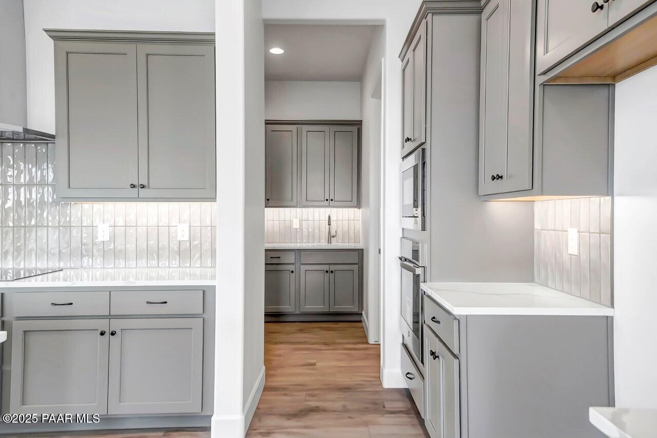 5229 Iron Vine Trail Prescott, AZ 86301 - Photo 7 of 92 a kitchen with a refrigerator sink and cabinets