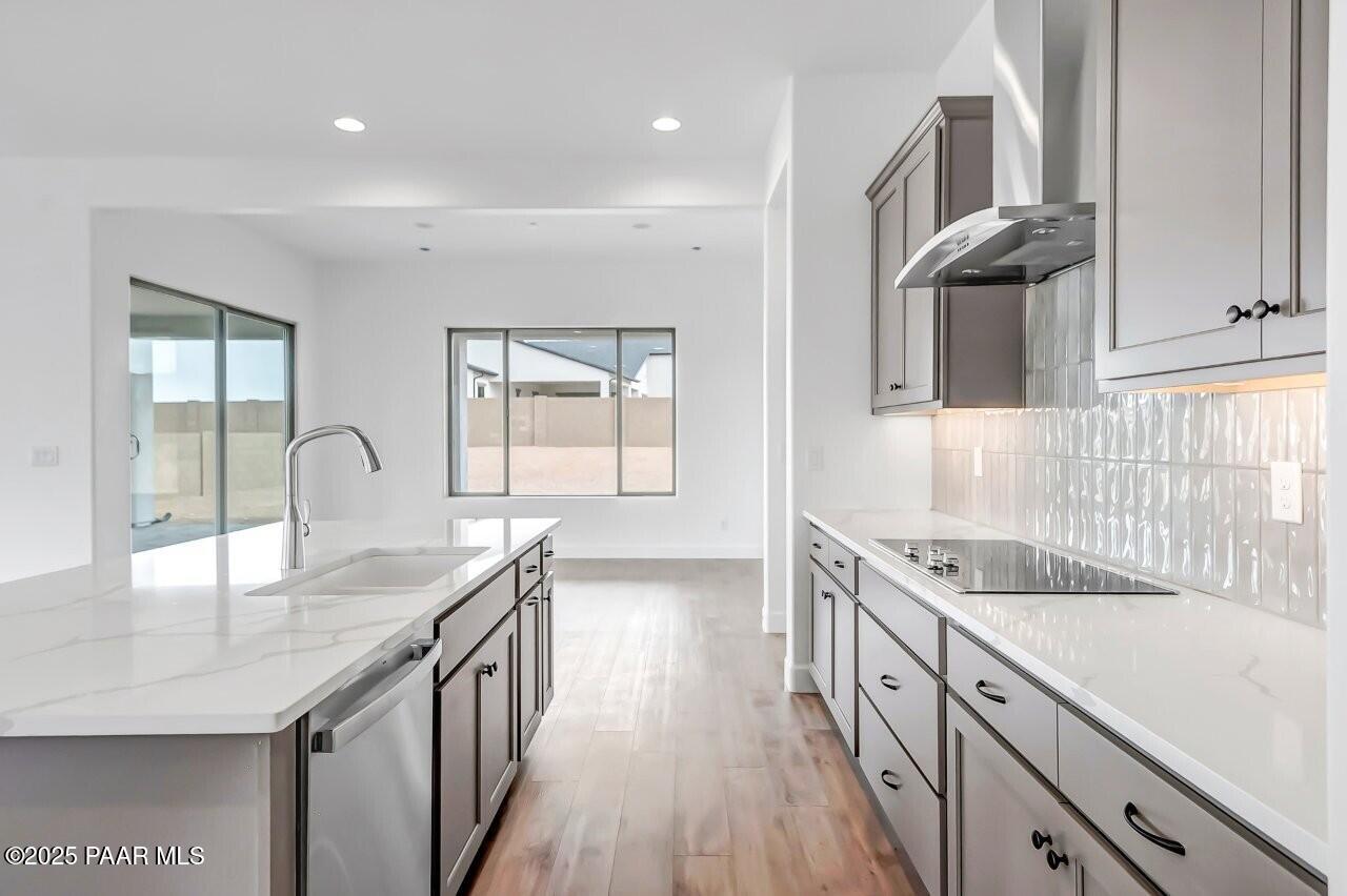 5229 Iron Vine Trail Prescott, AZ 86301 - Photo 10 of 92 a kitchen with granite countertop a sink stainless steel appliances and cabinets