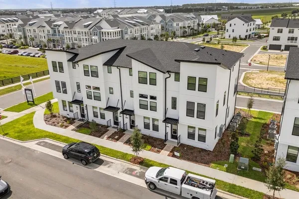 an aerial view of residential houses with outdoor space