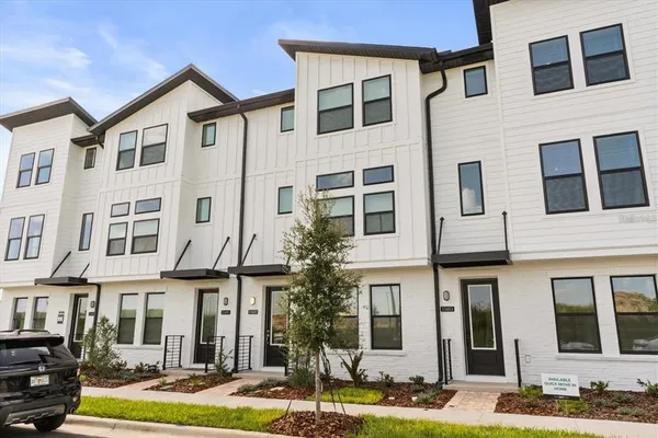 a front view of a residential apartment building with a yard