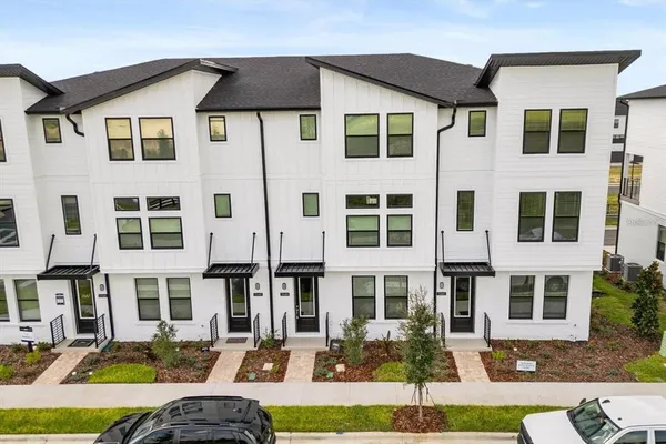 a front view of a residential apartment building with a yard