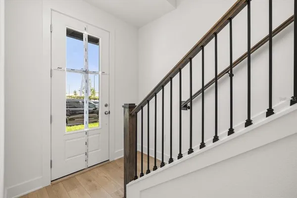 a view of staircase with lots of frames on wall and a window