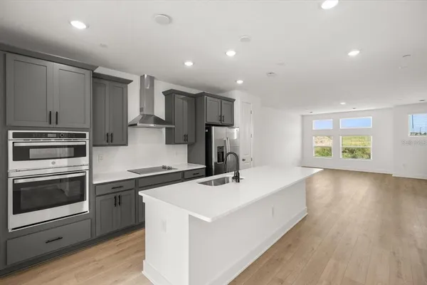 a kitchen with a sink stove and refrigerator