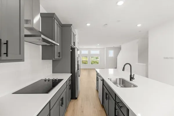 a kitchen with stainless steel appliances granite countertop a sink and a stove