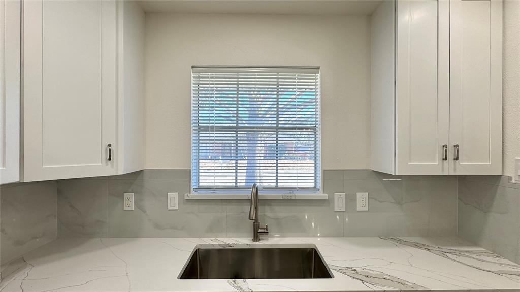 3915 Spring Hollow Drive Carrollton, TX 75007 - Photo 14 of 28 a kitchen with a white cabinets and a window
