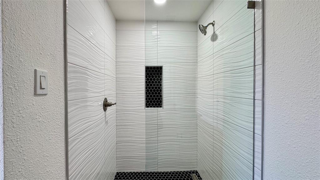 3915 Spring Hollow Drive Carrollton, TX 75007 - Photo 15 of 28 a bathroom with a shower
