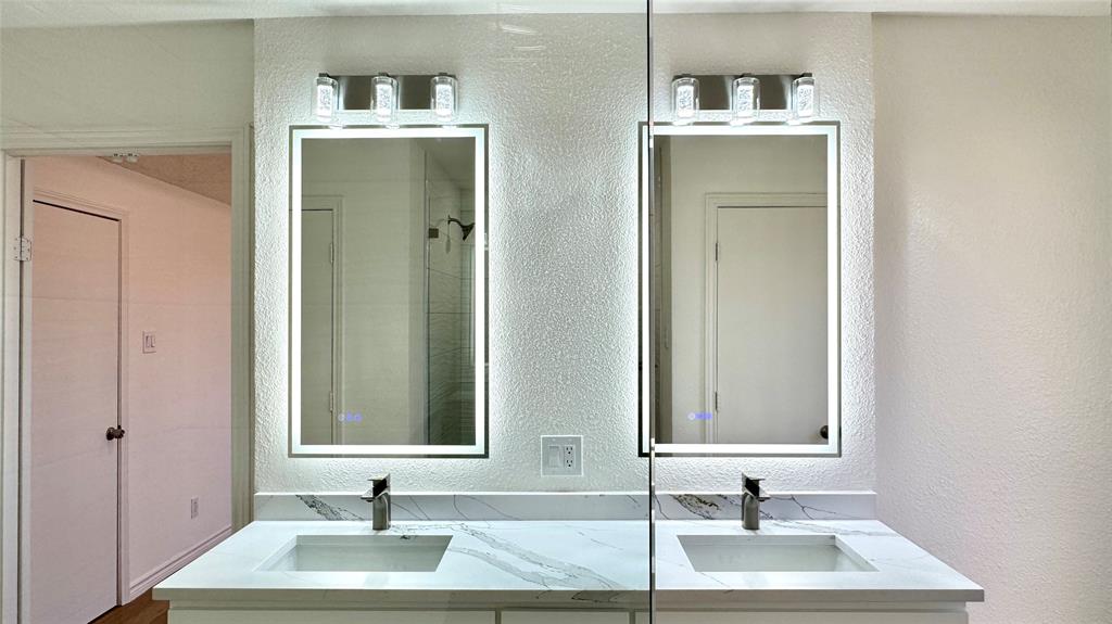3915 Spring Hollow Drive Carrollton, TX 75007 - Photo 17 of 28 a bathroom with a sink and a mirror