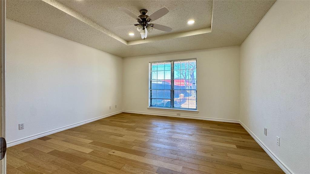 3915 Spring Hollow Drive Carrollton, TX 75007 - Photo 20 of 28 wooden floor in an empty room with a window
