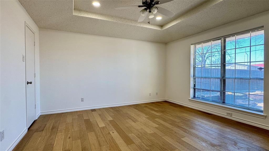 3915 Spring Hollow Drive Carrollton, TX 75007 - Photo 22 of 28 wooden floor in an empty room with a window