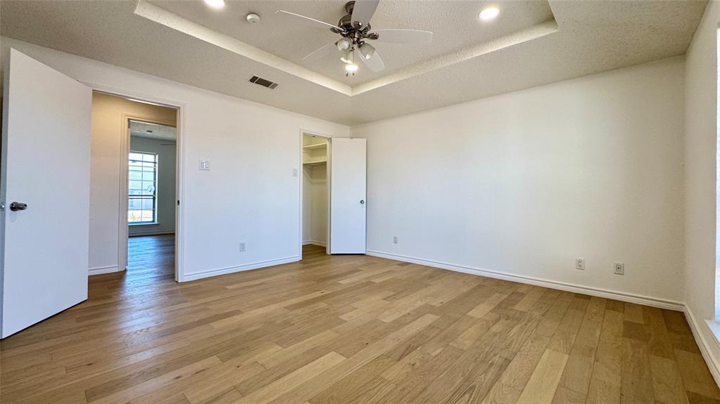 3915 Spring Hollow Drive Carrollton, TX 75007 - Photo 24 of 28 wooden floor in an empty room with a window
