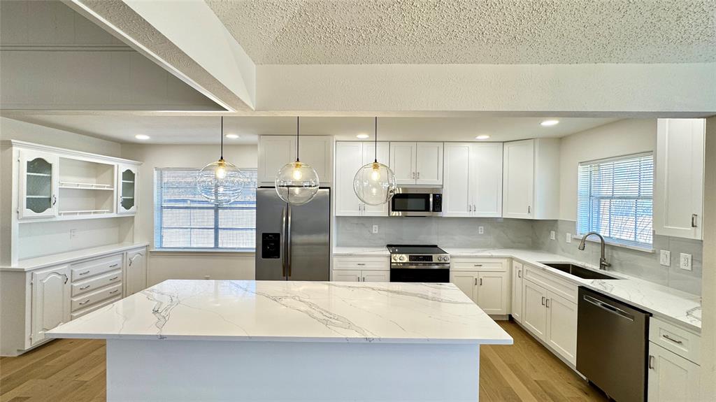 3915 Spring Hollow Drive Carrollton, TX 75007 - Photo 7 of 28 a large kitchen with a large counter top appliances and cabinets