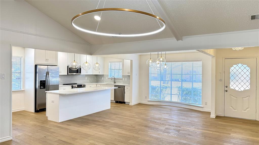 3915 Spring Hollow Drive Carrollton, TX 75007 - Photo 8 of 28 a view of kitchen with stainless steel appliances granite countertop a stove and a refrigerator