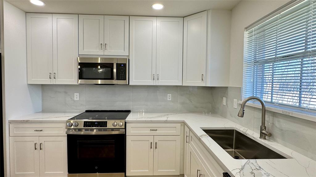3915 Spring Hollow Drive Carrollton, TX 75007 - Photo 10 of 28 a kitchen with appliances a sink and cabinets