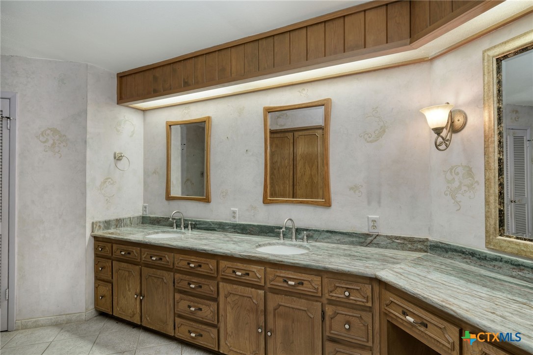 700 Breakaway Road Cedar Park, TX 78613 - Photo 11 of 38 a bathroom with a granite countertop double vanity sink and mirror