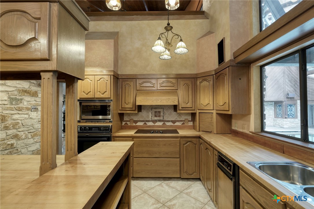 700 Breakaway Road Cedar Park, TX 78613 - Photo 6 of 38 a kitchen with a sink stainless steel appliances furniture and a window