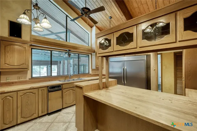 a view of a kitchen with a sink and cabinets