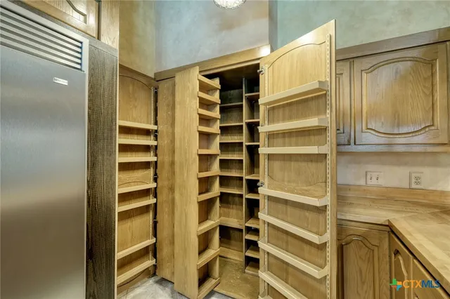 a view of walk in closet with empty racks