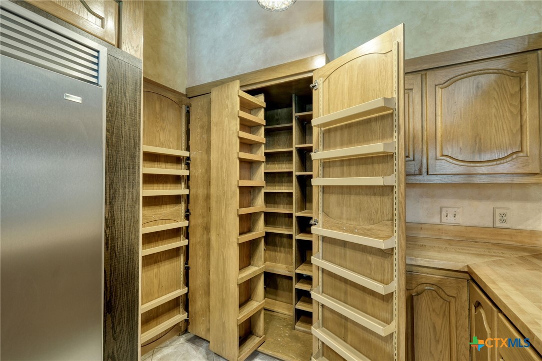 700 Breakaway Road Cedar Park, TX 78613 - Photo 8 of 38 a view of walk in closet with empty racks