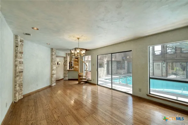 a view of a room with window and hardwood floor