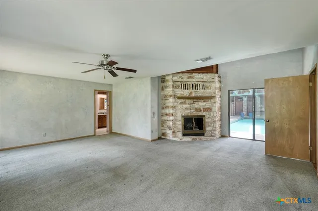 a view of a livingroom with an empty space and a fireplace