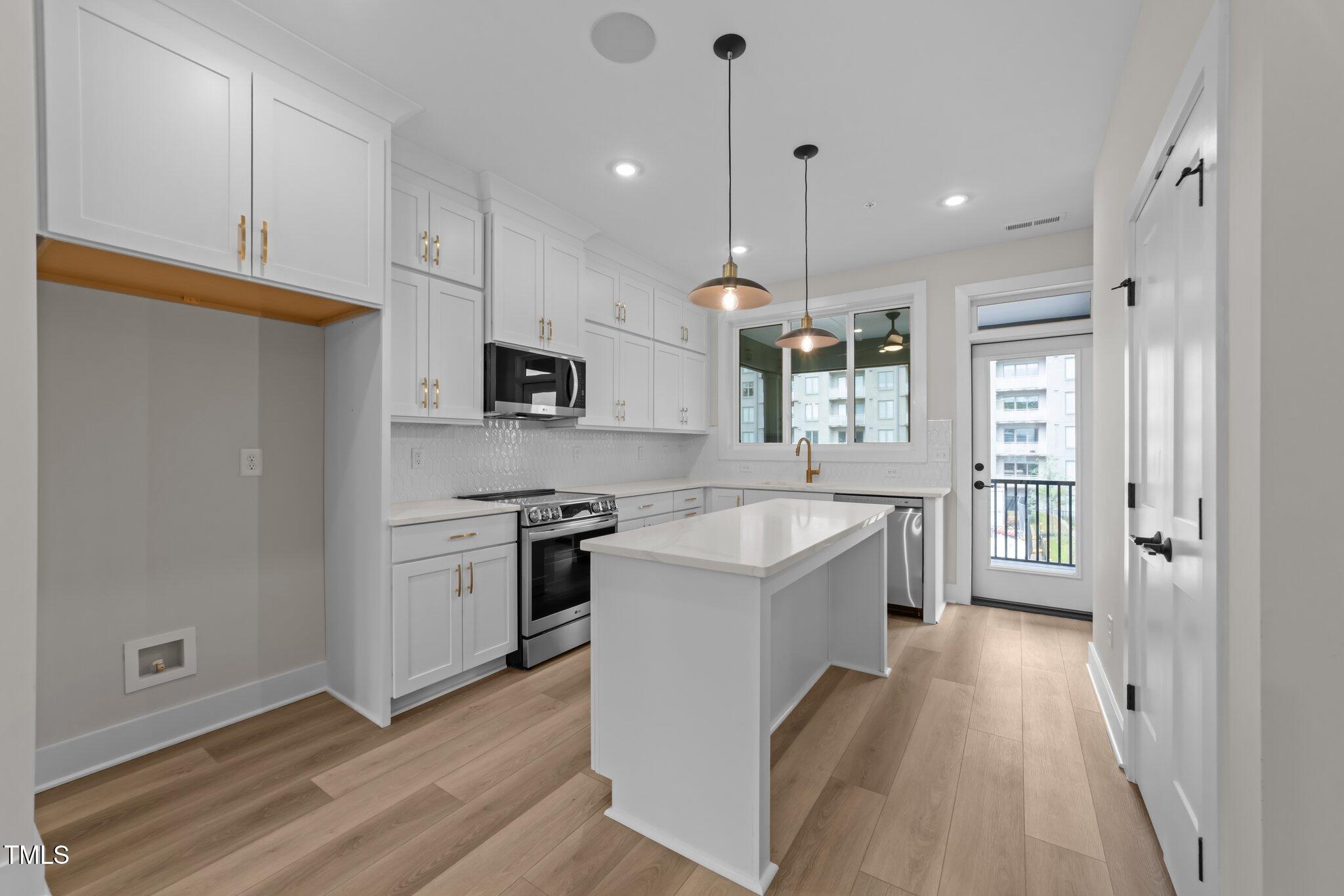 710 West North Street, Unit 101 Raleigh, NC 27603 - Photo 11 of 28 a kitchen with a sink stove and refrigerator