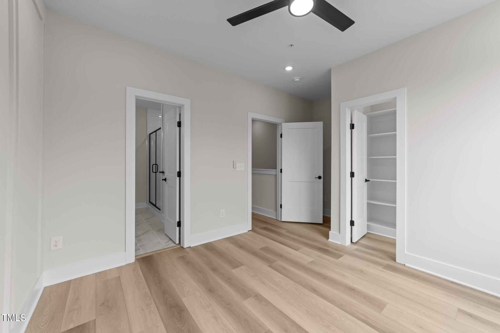 710 West North Street, Unit 101 Raleigh, NC 27603 - Photo 18 of 28 an empty room with closet and a chandelier fan