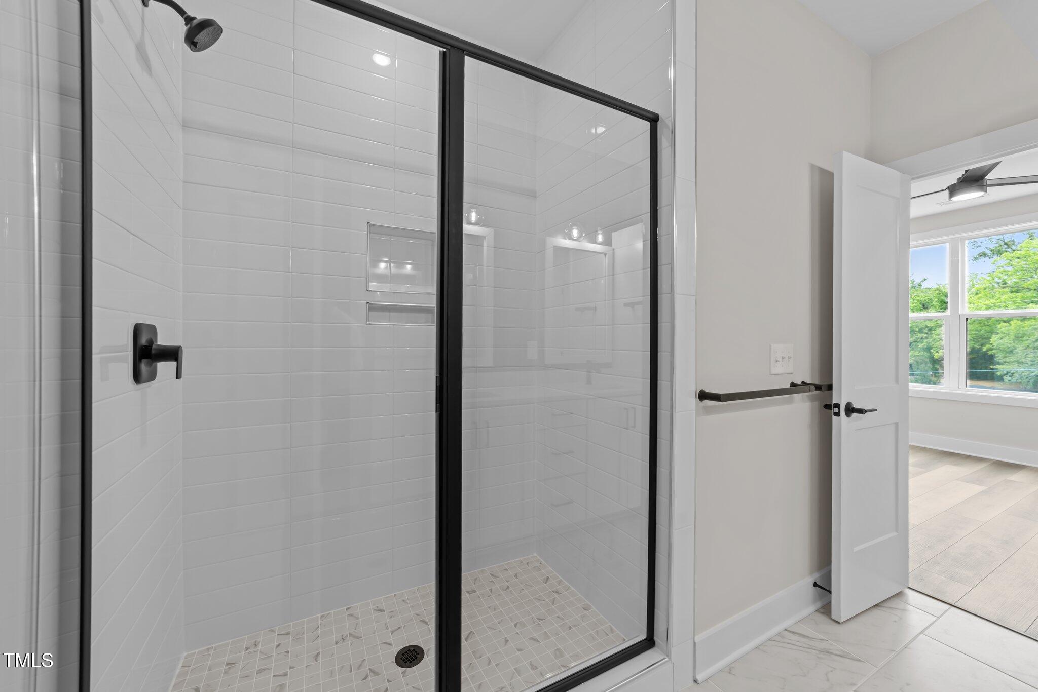 710 West North Street, Unit 101 Raleigh, NC 27603 - Photo 21 of 28 a bathroom with a glass shower door