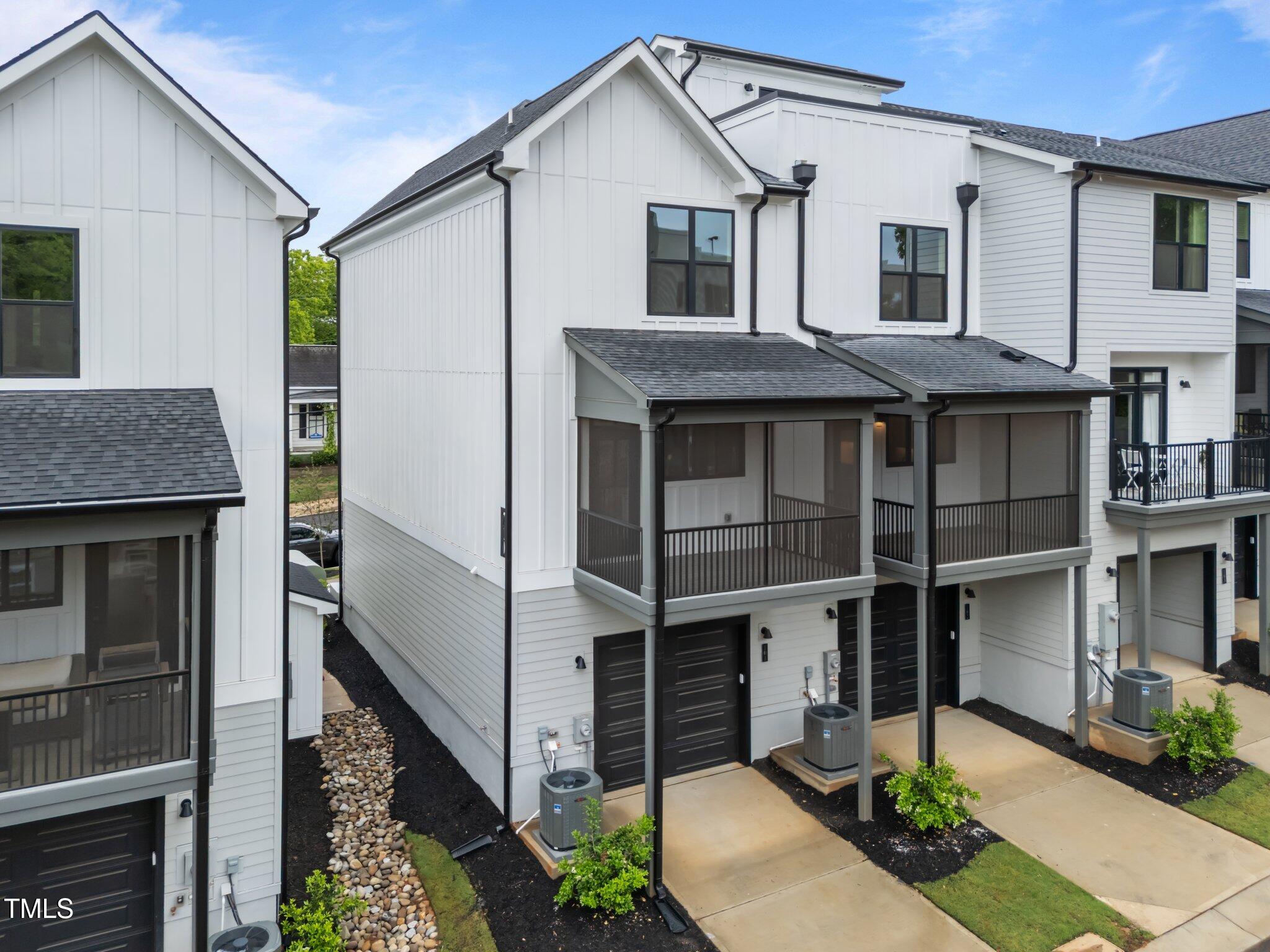 710 West North Street, Unit 101 Raleigh, NC 27603 - Photo 4 of 28 a view of a white house next to a yard