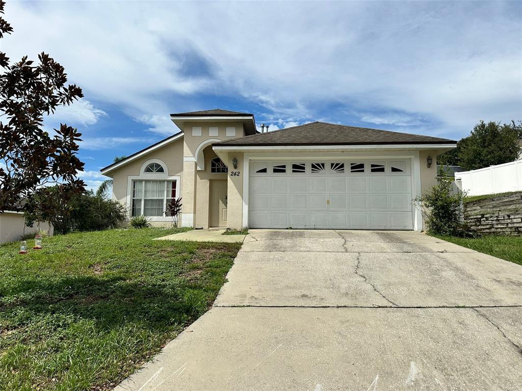 242 Durango Loop Street Davenport, FL 33897 - Photo 1 of 30 front view of a house with a yard