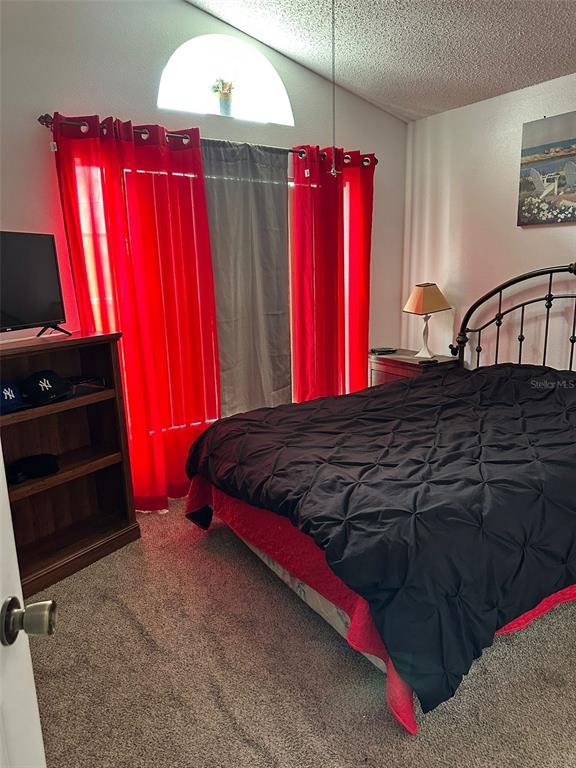 242 Durango Loop Street Davenport, FL 33897 - Photo 12 of 30 a bedroom with a bed and a furniture