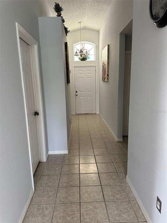 242 Durango Loop Street Davenport, FL 33897 - Photo 15 of 30 an empty room with kitchen space and window