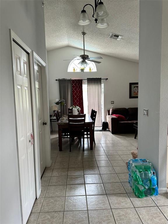 242 Durango Loop Street Davenport, FL 33897 - Photo 16 of 30 a living room with furniture and a chandelier