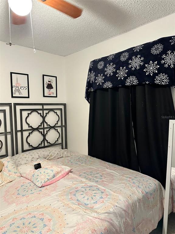 242 Durango Loop Street Davenport, FL 33897 - Photo 17 of 30 a bedroom with a bed and painting on the wall