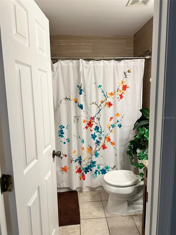 242 Durango Loop Street Davenport, FL 33897 - Photo 19 of 30 a bathroom with a sink and a white toilet