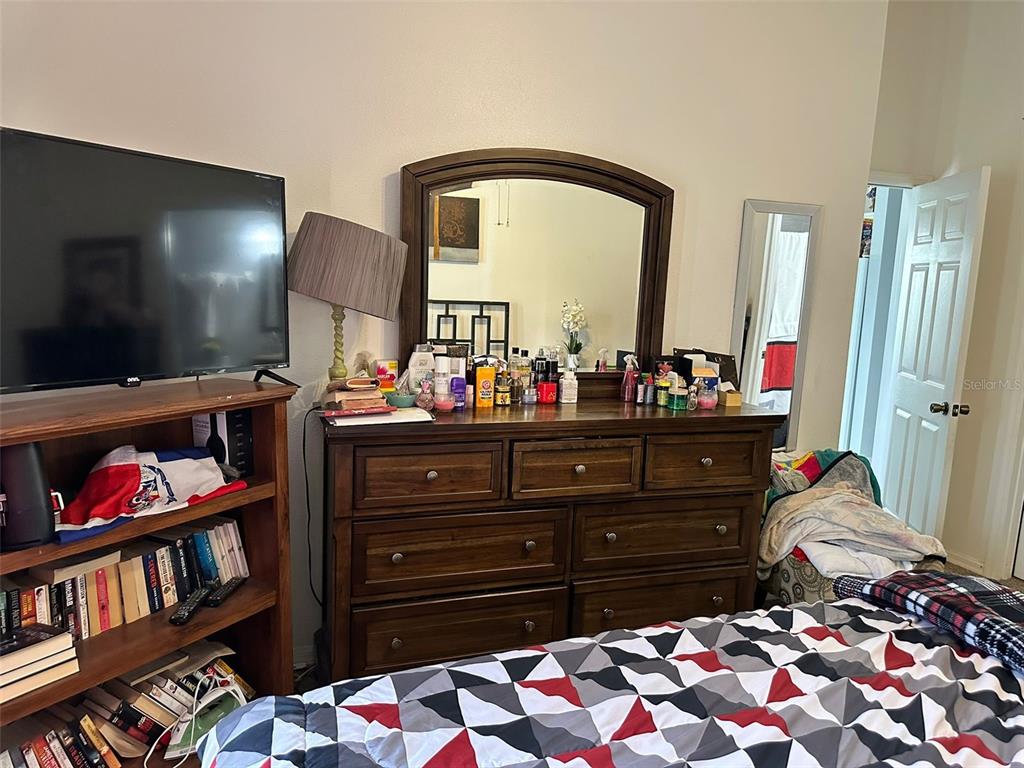 242 Durango Loop Street Davenport, FL 33897 - Photo 22 of 30 a bedroom with a bed and closet